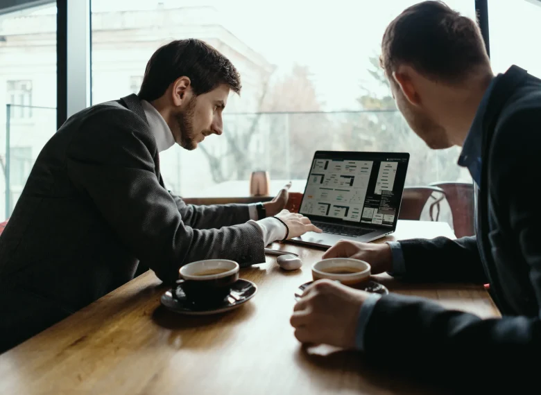 two-young-businessman-having-successful-meeting-restaurant